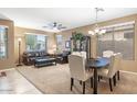Bright living room with carpet floors, a chandelier, and lots of natural light at 20529 N 94Th Ln, Peoria, AZ 85382