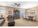 Cozy living room featuring carpet floors, elegant decor, and a ceiling fan at 20529 N 94Th Ln, Peoria, AZ 85382