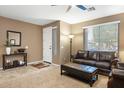 Comfortable living room with tile and carpet flooring, with a decorative table at 20529 N 94Th Ln, Peoria, AZ 85382