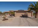 Charming home featuring desert landscaping, solar panels, and a three-car garage at 21730 N Black Bear Lodge Dr, Surprise, AZ 85387