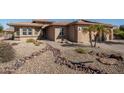 Stunning home featuring desert landscaping, native plants and unique rock features at 21730 N Black Bear Lodge Dr, Surprise, AZ 85387