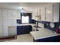 Efficient kitchen layout featuring ample cabinet space, modern appliances, and a bright window above the sink at 2207 N Shannon Way, Mesa, AZ 85215