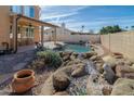 Resort-style pool and spa area with rock waterfall features and lush landscaping at 2332 S Brighton --, Mesa, AZ 85209