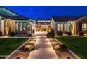 Beautiful walkway and manicured lawn leading to the front entrance of a well-lit home at 2656 E Oriole Dr, Gilbert, AZ 85297