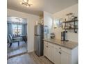 Kitchen featuring granite countertops, stainless steel refrigerator, and white cabinets at 2910 W Madison St, Phoenix, AZ 85009