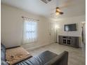 Bright living room featuring tile floors, neutral walls, and a ceiling fan at 2910 W Madison St, Phoenix, AZ 85009
