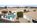 An aerial view of home with a fenced pool, desert landscaping, driveway, and a two-car garage at 320 S 70Th St # 54, Mesa, AZ 85208