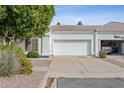 Charming single-story home with a two-car garage, desert landscaping and mature shade tree at 320 S 70Th St # 54, Mesa, AZ 85208