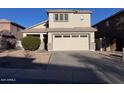Home exterior showing the two-car garage, driveway, and small front yard at 3229 S 93Rd Ave, Tolleson, AZ 85353