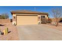 Charming single-story home featuring a two-car garage and desert landscaping at 35344 N Karan Swiss Cir, San Tan Valley, AZ 85143