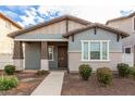 Attractive home featuring a covered porch, stylish color palette, and meticulously maintained front yard at 3868 E Robert St, Gilbert, AZ 85295