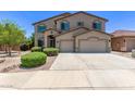 Beautiful two-story home with a three-car garage, manicured bushes, and an inviting driveway at 42735 W Bravo Dr, Maricopa, AZ 85138