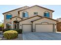 Charming two-story home with a three-car garage and inviting covered entryway at 42735 W Bravo Dr, Maricopa, AZ 85138