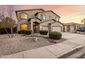Desert landscaped home with a two-story elevation, three-car garage and covered entry at 42735 W Bravo Dr, Maricopa, AZ 85138