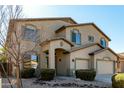 Inviting two-story home with a three-car garage, desert landscaping and inviting covered entryway at 42735 W Bravo Dr, Maricopa, AZ 85138