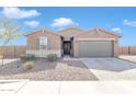 Charming single-story home with a well-maintained front yard, stone accents, desert landscaping, and a two-car garage at 4507 E Warlander Ln, San Tan Valley, AZ 85140