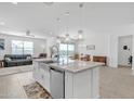 Open-concept kitchen featuring a large island, stainless steel appliances, granite countertops, and ample cabinet space at 4507 E Warlander Ln, San Tan Valley, AZ 85140