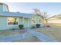 Charming exterior with light green siding, manicured bushes, and tidy landscaping at 4731 N 26Th Ln, Phoenix, AZ 85017