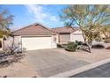 Charming single-story home featuring a well-maintained front yard, desert landscaping and a two-car garage at 4744 E Laredo Ln, Cave Creek, AZ 85331