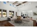 Open concept space with wood beams, chandelier, large windows, and comfortable seating at 9412 E Hidden Spur Trl, Scottsdale, AZ 85255