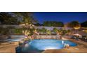 A stunning pool with water features and lush landscaping, creating a serene and private backyard oasis at 9412 E Hidden Spur Trl, Scottsdale, AZ 85255
