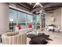 Open living room with a modern design, neutral colors, and city views at 1 E Lexington Ave # 1210, Phoenix, AZ 85012