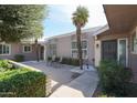 Private courtyard with seating area, mature trees, and lush landscaping at 10461 W Loma Blanca Dr, Sun City, AZ 85351