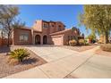 Beautiful two-story home with a tile roof, spacious driveway, and well-maintained landscaping at 10684 N 161St Ave, Surprise, AZ 85379