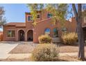 Charming two-story home with a tile roof, arched windows, and desert landscaping at 10684 N 161St Ave, Surprise, AZ 85379