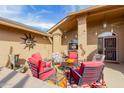 Inviting patio with comfortable seating, string lights, and decorative sun art, perfect for outdoor gatherings at 11530 E Monterey Ave, Mesa, AZ 85209