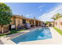 Backyard pool features a well-maintained pool with a patio, BBQ, and ample space for outdoor entertaining at 11530 E Monterey Ave, Mesa, AZ 85209