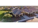 Aerial view of a home in a residential neighborhood with a manicured lawn and tile roof at 12413 W Calle De Baca --, Peoria, AZ 85383