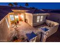 Inviting front courtyard featuring beautiful brick pavers, outdoor seating, and decorative plants at 12936 W Sola Dr, Sun City West, AZ 85375