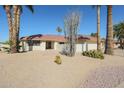 Charming home featuring desert landscaping, mature palm trees, and a two-car garage at 13232 W Ballad Dr, Sun City West, AZ 85375