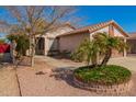 Inviting single-story home with desert landscaping and a walkway to the entrance at 14946 W Caribbean Ln, Surprise, AZ 85379