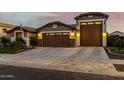 Inviting single-story home featuring a well-manicured lawn, desert landscaping, and attached three-car garage at 17793 W Corrine Dr, Surprise, AZ 85388