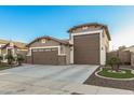 Inviting single-story home featuring a well-manicured lawn, desert landscaping, and attached three-car garage at 17793 W Corrine Dr, Surprise, AZ 85388