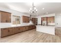Spacious kitchen with a large island, stainless steel appliances, and stylish lighting, perfect for modern living at 18192 W Ashley Dr, Goodyear, AZ 85338