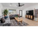 This open living room is furnished with a comfortable sofa and a stylish ceiling fan at 2041 W Palo Verde Dr, Phoenix, AZ 85015