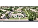 Lovely aerial view of a single-story home with desert landscaping and mature trees, set within a peaceful neighborhood at 2251 N 32Nd St # 21, Mesa, AZ 85213