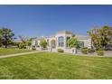 A beautiful single-story home with a lush green lawn under a clear blue sky at 2251 N 32Nd St # 21, Mesa, AZ 85213