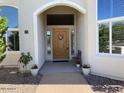 Inviting front entrance features a classic wooden door, decorative plants, and sidelight windows for natural light at 2251 N 32Nd St # 21, Mesa, AZ 85213