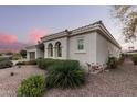 Exterior view of a charming home featuring stucco siding and lovely landscaping at 23116 N Padaro Ct, Sun City West, AZ 85375