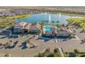 Gorgeous aerial view of community center with pool, lake, and lush desert landscaping at 24670 N 171St Ln, Surprise, AZ 85387