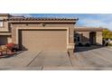 Large tan garage door with well maintained landscaping and a seating area at 2528 E La Costa Dr, Chandler, AZ 85249