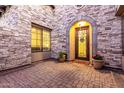 Charming front porch with stone accents, potted plants, and an elegant front door with a decorative grille at 2799 E Waterman St, Gilbert, AZ 85297