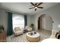 Open-concept living room with stylish furniture, a view of the entry, and a ceiling fan at 2902 E Escondido Ave, Mesa, AZ 85204