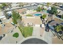 Aerial view of single-story home, showcasing well-manicured lawn, RV parking, and proximity to a community pool at 3119 S Stewart Cir, Mesa, AZ 85202