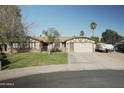 Lovely single-story home featuring a well-manicured lawn, two-car garage, and RV parking in the driveway at 3119 S Stewart Cir, Mesa, AZ 85202