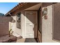 Inviting front entrance with a security screen door and decorative outdoor lighting at 3232 E Hononegh Dr, Phoenix, AZ 85050